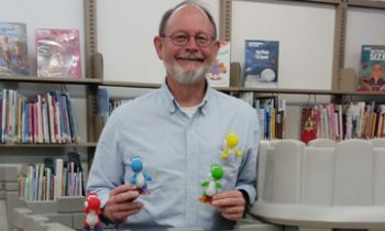 Award-winning author gives donation to library project